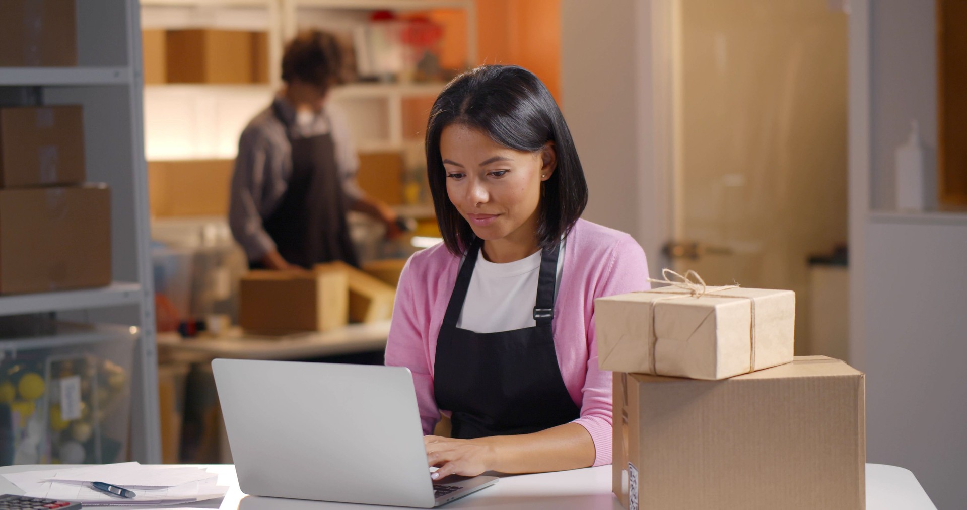 Young African-American businesswoman check product purchase order on stock and save to laptop work at office